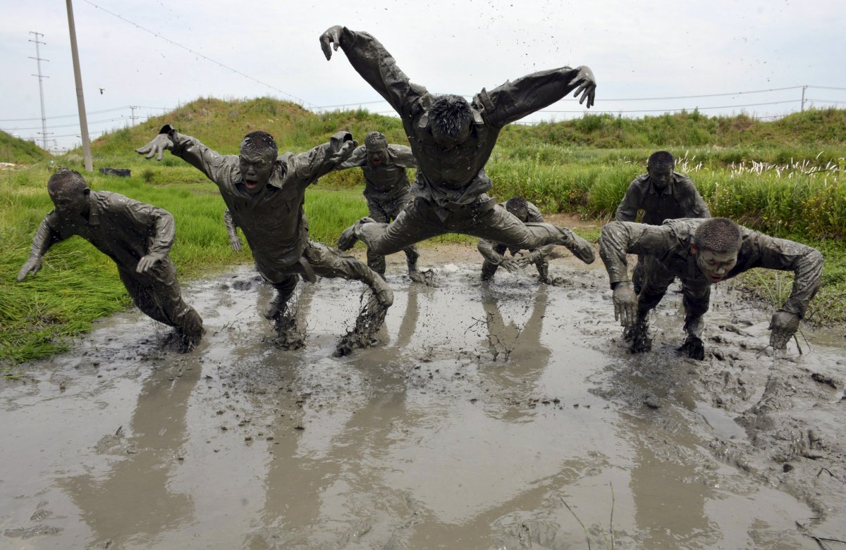 in-mainland-china-paramilitary-policeman-face-an-intense-regimen-here-the-policemen-take-part-in-a-training-session-in-muddy-water