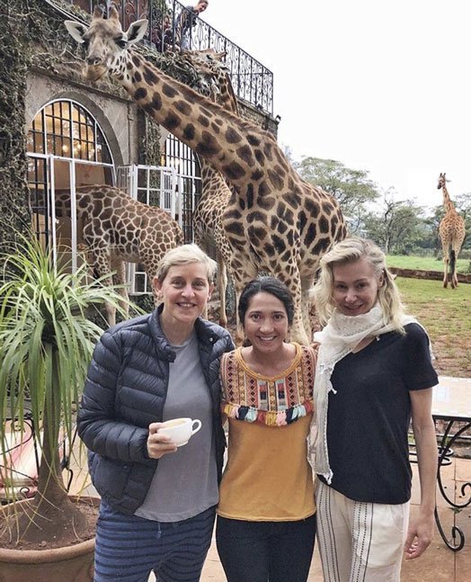 Ellen DeGeneres, her wife Portia de Rossi and a friend pose for a photo at the Giraffe Manor
