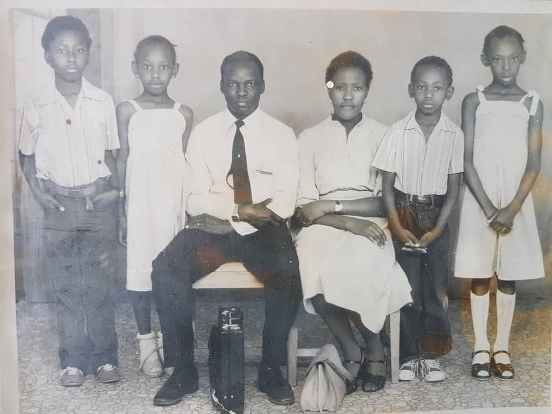 A young Carol Radull (second left) stands close to her father in the old family photo