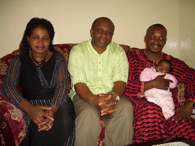 Prophet Elisha Muliri carries his daughter Wonder Glory when she was still months old. Seated on the left is Angela Chibalonza.