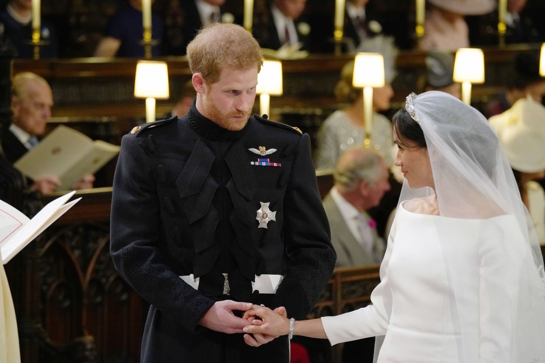 Britain's Prince Harry and Meghan Markle during their wedding ceremony in St George's Chapel, Windsor Castle, in Windsor, on May 19, 2018. (Photo by Jonathan Brady / POOL / AFP)