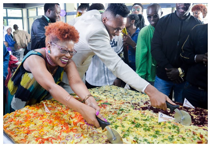 DJ Mo goes down in record books after taking up challenge to eat largest pizza in East Africa (Photos)