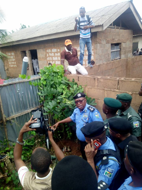 Police examine the spot where the prophet buried the woman's head and hands