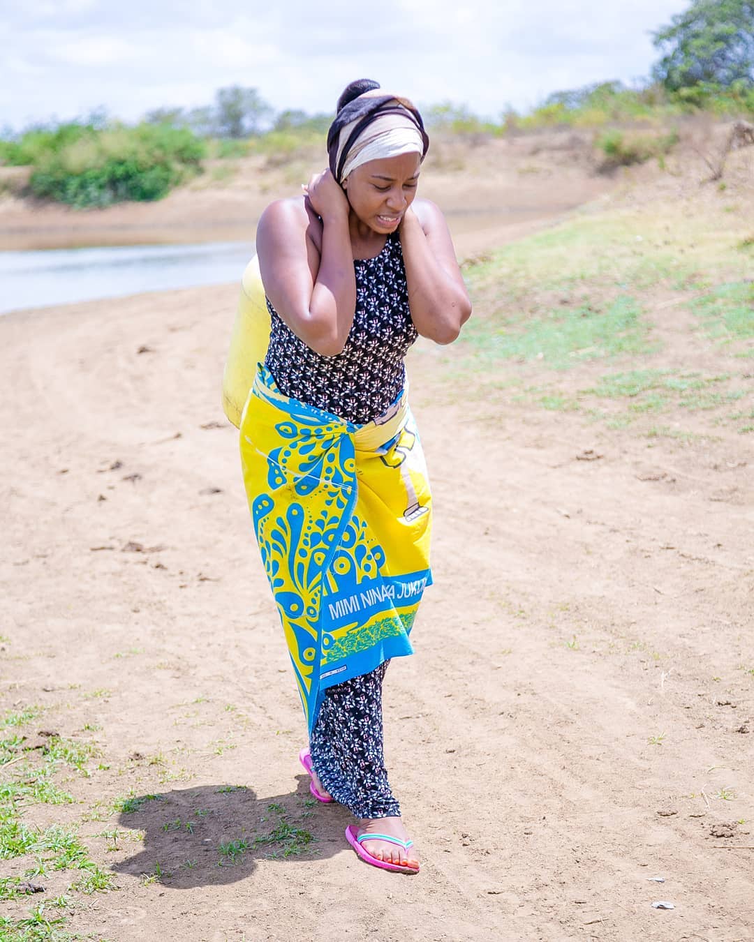 Diana Marua carries a 20 litre jerrycan on her back during her visit to Ukambani