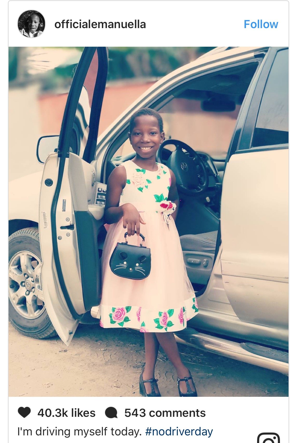 Cute photo of comedienne Emmanuela as she poses in front of a SUV, indicating she would drive herself.